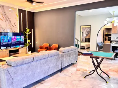 a living room with a couch and a tv at CornerDouble-Storey&KTV Snooker 16Pax Ipoh By MICASA GROUP in Ipoh