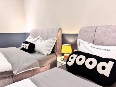 a bedroom with a bed and a chair with a pillow at CornerDouble-Storey&KTV Snooker 16Pax Ipoh By MICASA GROUP in Ipoh