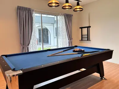 a pool table with two cuesticks in a room at CornerDouble-Storey&KTV Snooker 16Pax Ipoh By MICASA GROUP in Ipoh
