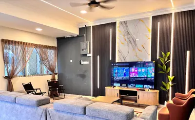 a living room with two couches and a flat screen tv at CornerDouble-Storey&KTV Snooker 16Pax Ipoh By MICASA GROUP in Ipoh