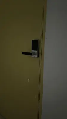 a door with a black handle in a room at Rest N Go CM in Ipoh