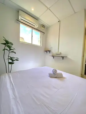 a bedroom with a large white bed with a window at Sembilan Inn by Soft Loft in George Town