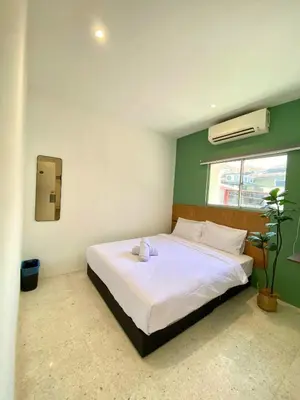 a bedroom with a bed with a stuffed animal on it at Sembilan Inn by Soft Loft in George Town