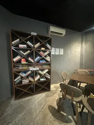 a room with a book shelf filled with wine bottles at The Century Hostel George Town \u4e54\u6cbb\u5e02\u4e16\u7eaa\u9752\u65c5 in George Town