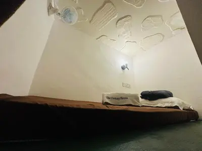 a bed in a room with a ceiling with stickers at The Century Hostel George Town \u4e54\u6cbb\u5e02\u4e16\u7eaa\u9752\u65c5 in George Town