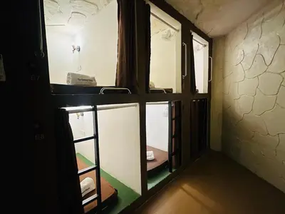 a room with two windows and a room with a ladder at The Century Hostel George Town \u4e54\u6cbb\u5e02\u4e16\u7eaa\u9752\u65c5 in George Town