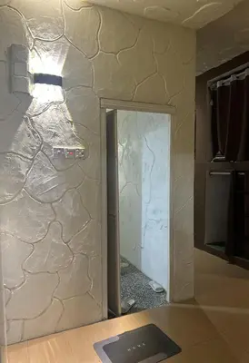 a room being remodeled with a stone wall at The Century Hostel George Town \u4e54\u6cbb\u5e02\u4e16\u7eaa\u9752\u65c5 in George Town