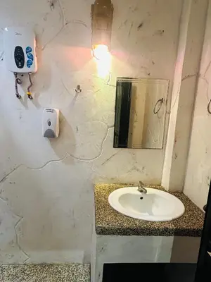 a bathroom with a sink and a mirror at The Century Hostel George Town \u4e54\u6cbb\u5e02\u4e16\u7eaa\u9752\u65c5 in George Town