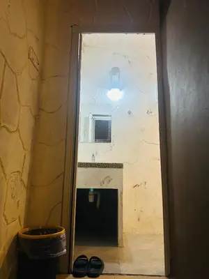 a door to a bathroom in a room with a wall at The Century Hostel George Town \u4e54\u6cbb\u5e02\u4e16\u7eaa\u9752\u65c5 in George Town