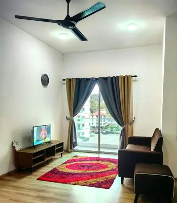 a living room with a couch and a ceiling fan at KAZ homestay in Tanah Rata
