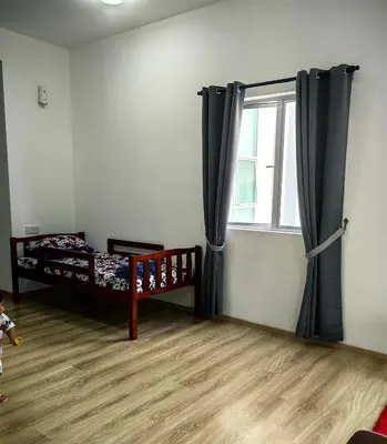 a bedroom with two bunk beds and a window at KAZ homestay in Tanah Rata