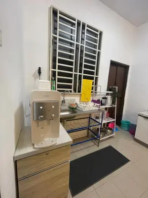 a room with a sewing machine sitting on a desk at Orked Homestay 2 Parit Buntar in Parit Buntar