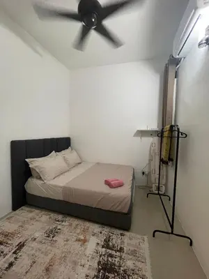 a bedroom with a bed with a ceiling fan at Orked Homestay 2 Parit Buntar in Parit Buntar