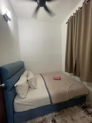 a bedroom with a bed with a ceiling fan at Orked Homestay 2 Parit Buntar in Parit Buntar