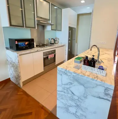 a kitchen with a marble counter top at Straits Quay Seaview in Tanjung Bungah