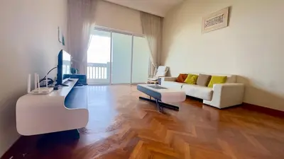 a living room with a couch and a table at Straits Quay Seaview in Tanjung Bungah