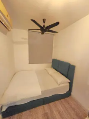 a room with a bed with a ceiling fan at The Majestic Privilege Suites - Ipoh in Ipoh