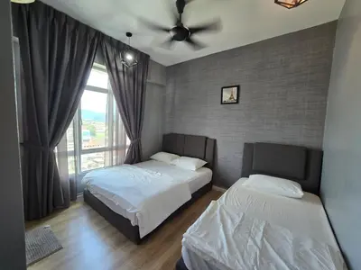 a bedroom with two beds and a ceiling fan at The Majestic Privilege Suites - Ipoh in Ipoh