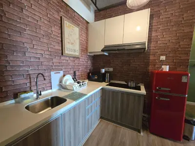a kitchen with a sink and a red refrigerator at The Majestic Privilege Suites - Ipoh in Ipoh