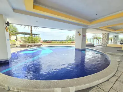 a large swimming pool in the middle of a house at The Majestic Privilege Suites - Ipoh in Ipoh