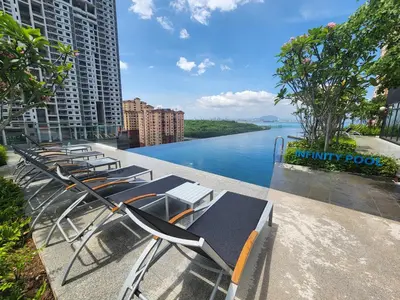 a row of chairs sitting next to a river at Urban Suite the Privilege Suites by Merveille in George Town