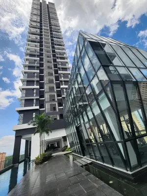 a tall building with a pool in front of it at Urban Suite the Privilege Suites by Merveille in George Town