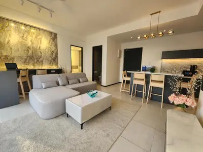 a living room with a white couch and a table at Urban Suite the Privilege Suites by Merveille in George Town