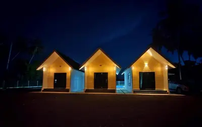 a house is lit up at night at Desa Damai Homestay in Penaga