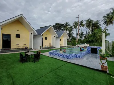 a house with a swimming pool in the yard at Desa Damai Homestay in Penaga