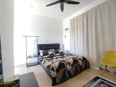 a bedroom with a bed and a ceiling fan at Desa Damai Homestay in Penaga