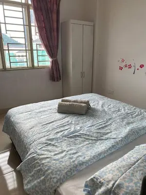 a bedroom with a large bed with a pillow on it at Easy Access to Airport, USM & Queensbay in Bayan Lepas