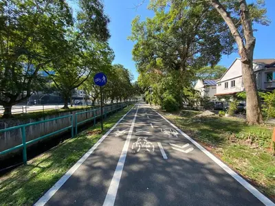an empty street with a bike lane on it at Easy Access to Airport, USM & Queensbay in Bayan Lepas