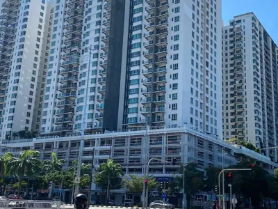 a group of tall buildings in a city at Easy Access to Airport, USM & Queensbay in Bayan Lepas