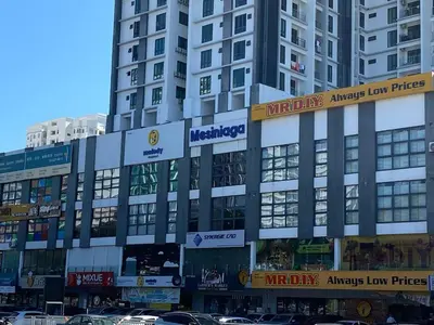 a large building with signs on the side of it at Easy Access to Airport, USM & Queensbay in Bayan Lepas