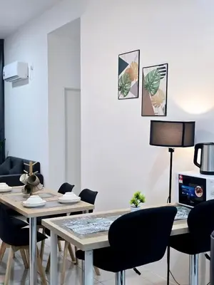 a dining room with a table and chairs at d05 The Anderson Ipoh Family Stay 2BR in Ipoh