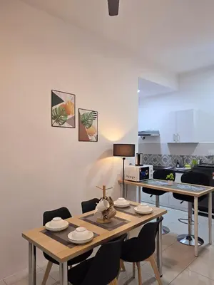 a kitchen and dining room with a table and chairs at d05 The Anderson Ipoh Family Stay 2BR in Ipoh