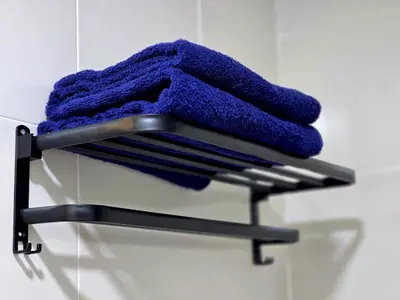 a towel rack with a pile of purple towels at c06 The Anderson Ipoh Family Stay 2BR in Ipoh