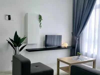 a living room with a tv and a table at c06 The Anderson Ipoh Family Stay 2BR in Ipoh