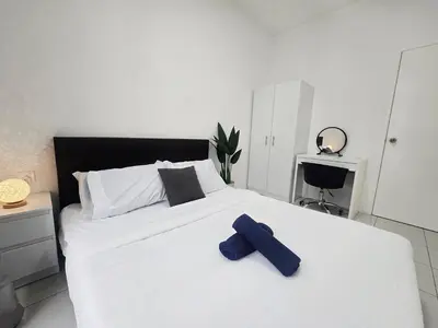 a large white bed with a blue object on it at d10 The Anderson Ipoh Family Stay 2BR in Ipoh