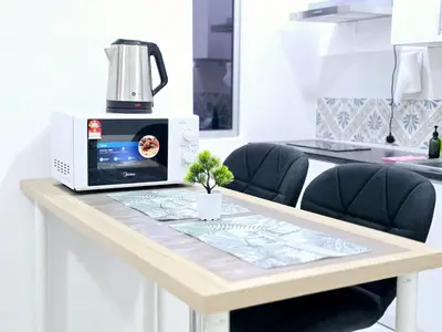 a microwave sitting on top of a table at d10 The Anderson Ipoh Family Stay 2BR in Ipoh