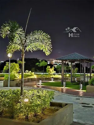 a palm tree and a gazebo in a park at night at b07 The Anderson Ipoh Family Stay 2BR in Ipoh