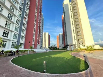 a grassy area in a city with tall buildings at b07 The Anderson Ipoh Family Stay 2BR in Ipoh