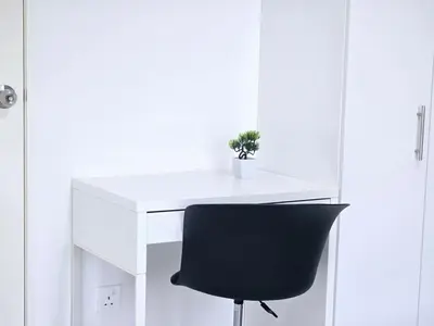 a black chair sitting next to a white desk at b07 The Anderson Ipoh Family Stay 2BR in Ipoh