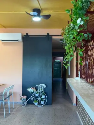 a bike parked next to a wall with a corridor at TY Youth Hostel in Sekincan