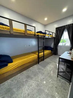 a room with two bunk beds and a desk at TY Youth Hostel in Sekincan