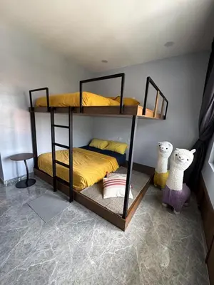 a bedroom with two bunk beds in a room at TY Youth Hostel in Sekincan