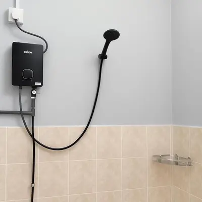 a shower in a bathroom with a microphone on the wall at TK Homie in Tanjung Karang