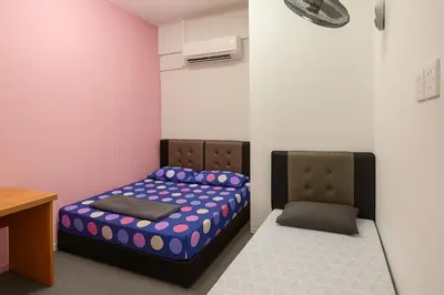 a room with a bed and a desk in it at TK Homie in Tanjung Karang