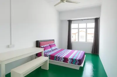 a white room with a bed and a window at TK Homie in Tanjung Karang