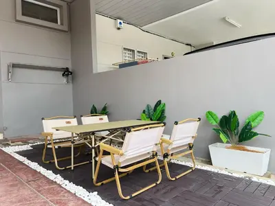 a patio with a table and four chairs at BM Alma Aeonjusco Auto City Homestay in Bukit Mertajam